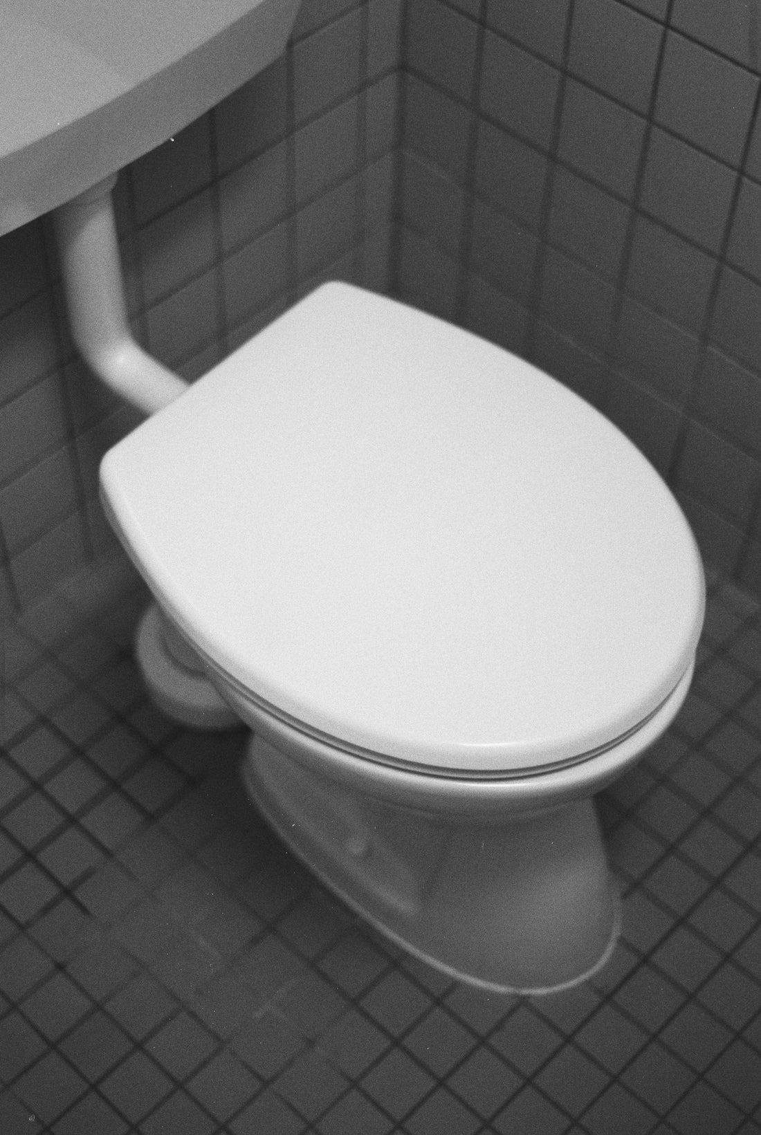 Real toilet in a tiled bathroom